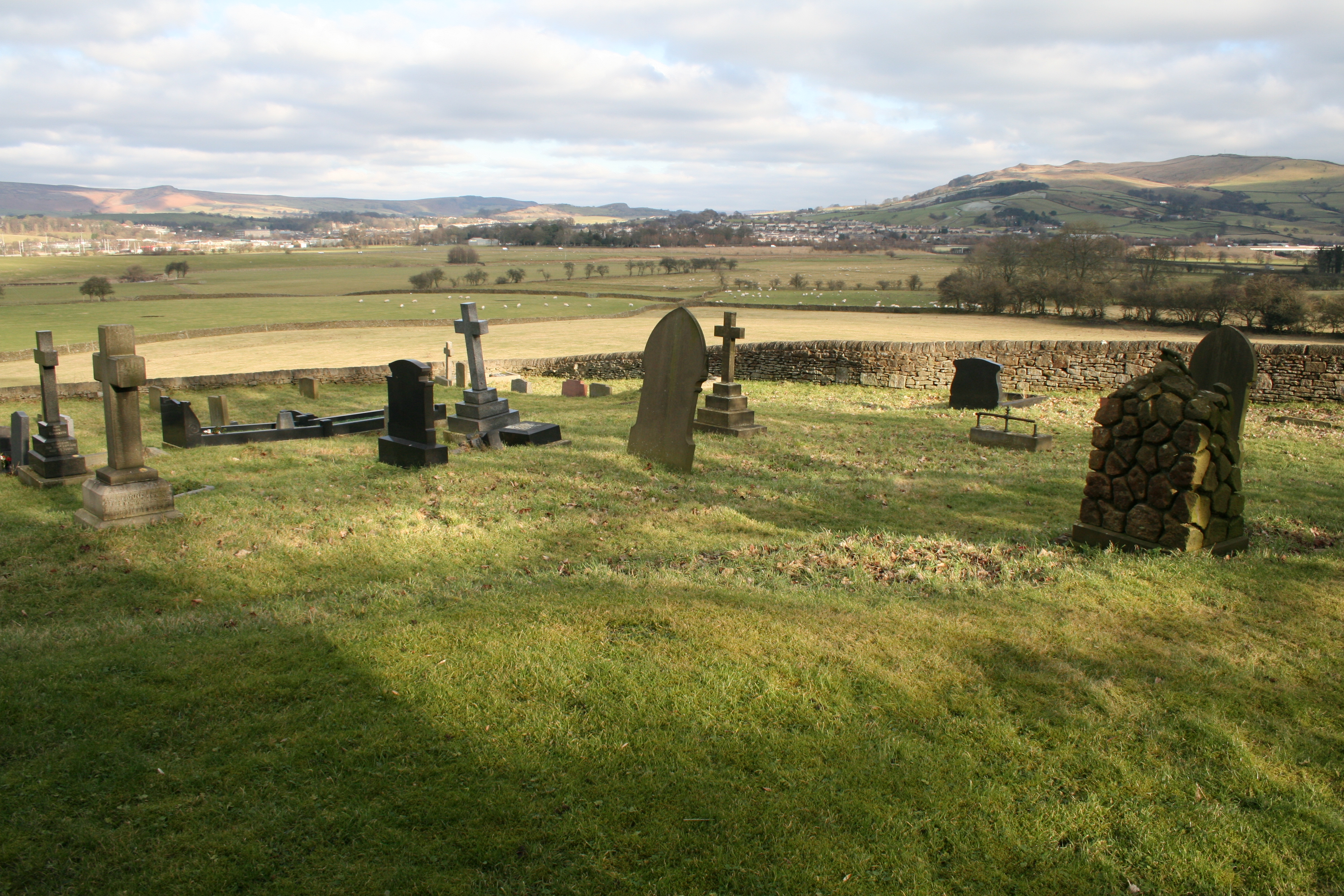 Carleton graveyard with stone headstones overlooking Craven valley.