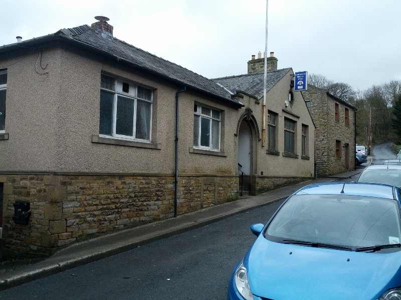 Stone building with windows and a sign in Carleton, North Yorkshire