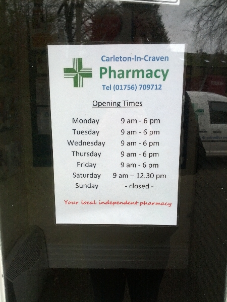 Carleton-in-Craven Pharmacy opening hours sign in North Yorkshire