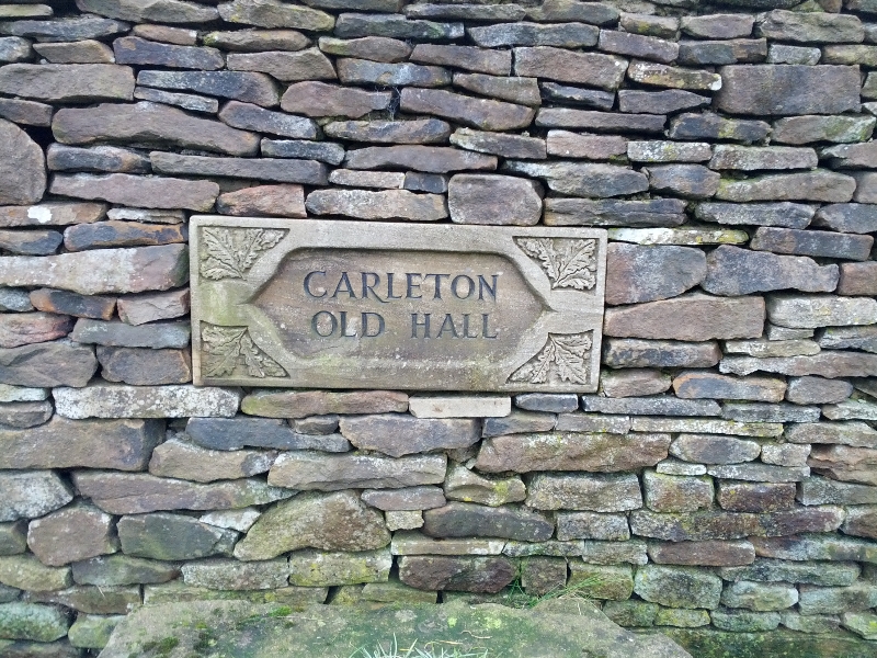 Stone wall with Carleton Old Hall sign in North Yorkshire, UK