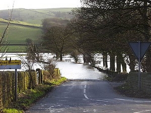 Flooded road blocked sign in Carleton, North Yorkshire, during heavy rain