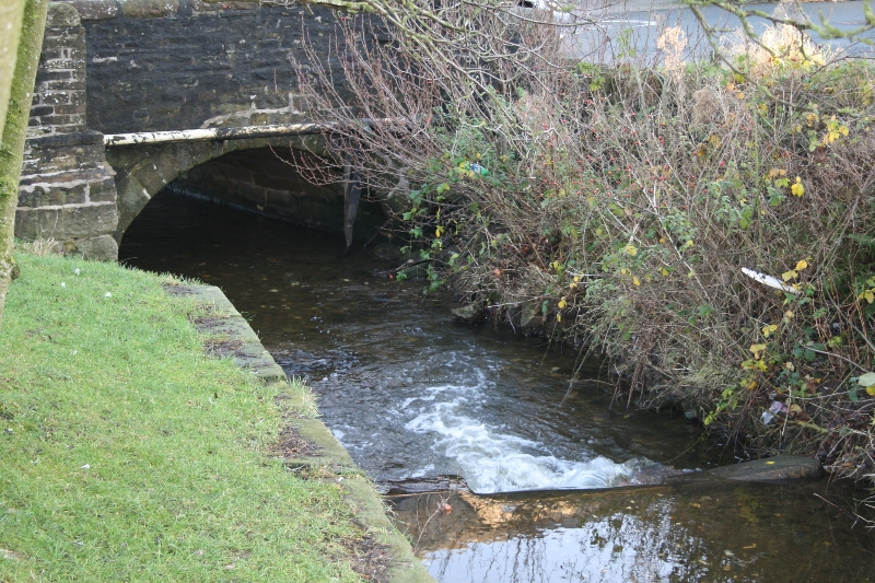 Stone bridge over a stream in Carleton, North Yorkshire, UK.